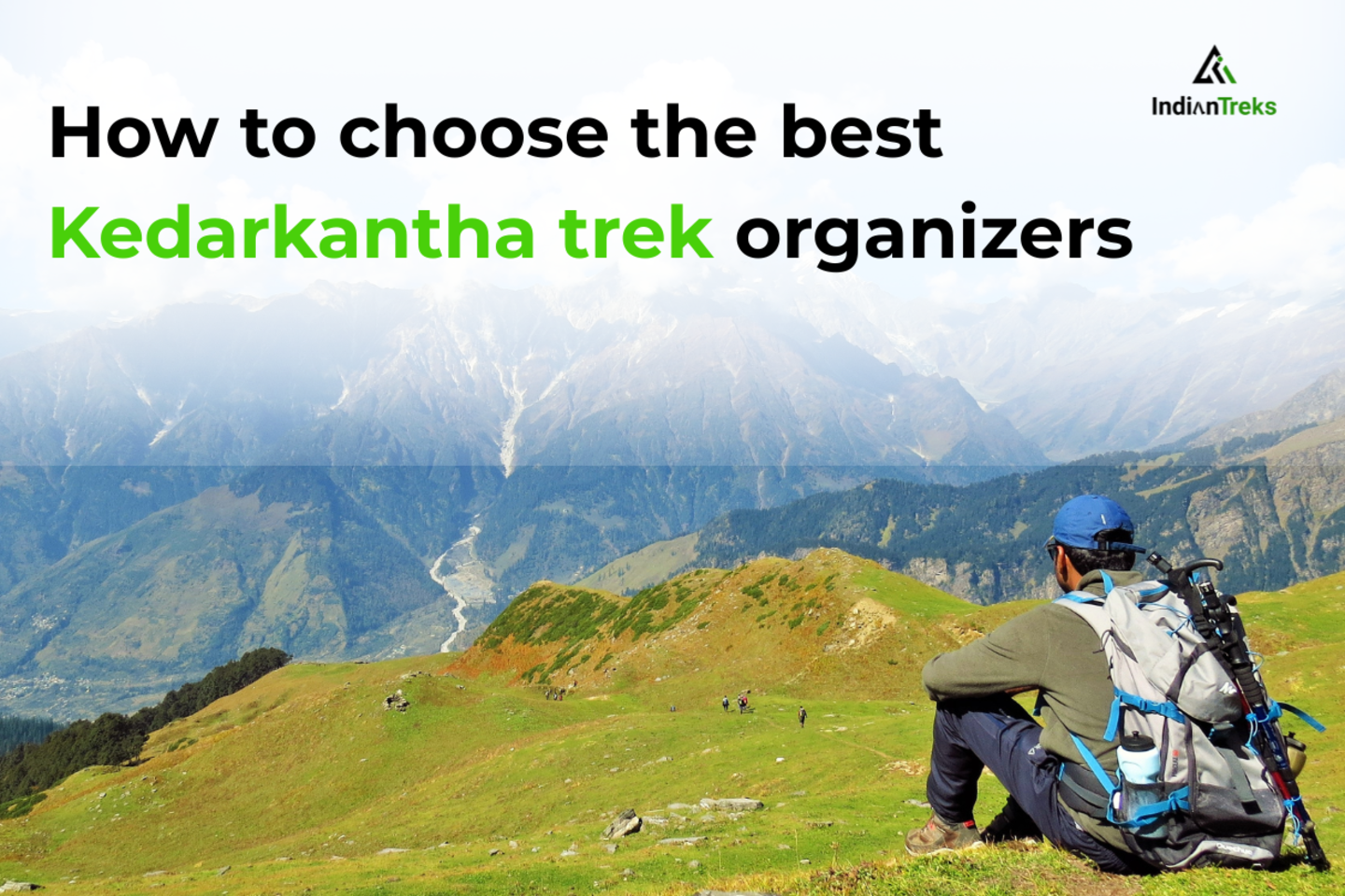 Trekkers hiking through snow-clad trails on the Kedarkantha trek with pine forests in the background
